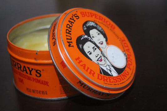 a tin of hair dressing sitting on a table