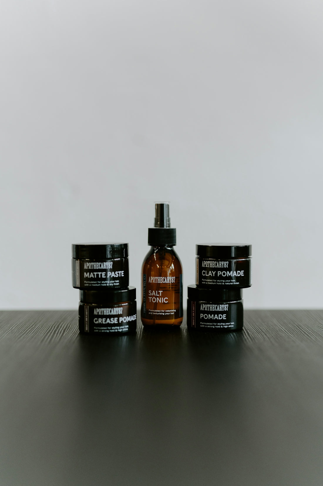 Hair styling products including pomade, paste, and tonic.