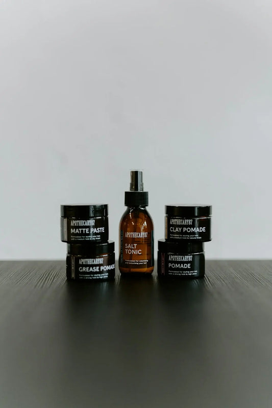Hair styling products including pomade, paste, and tonic.